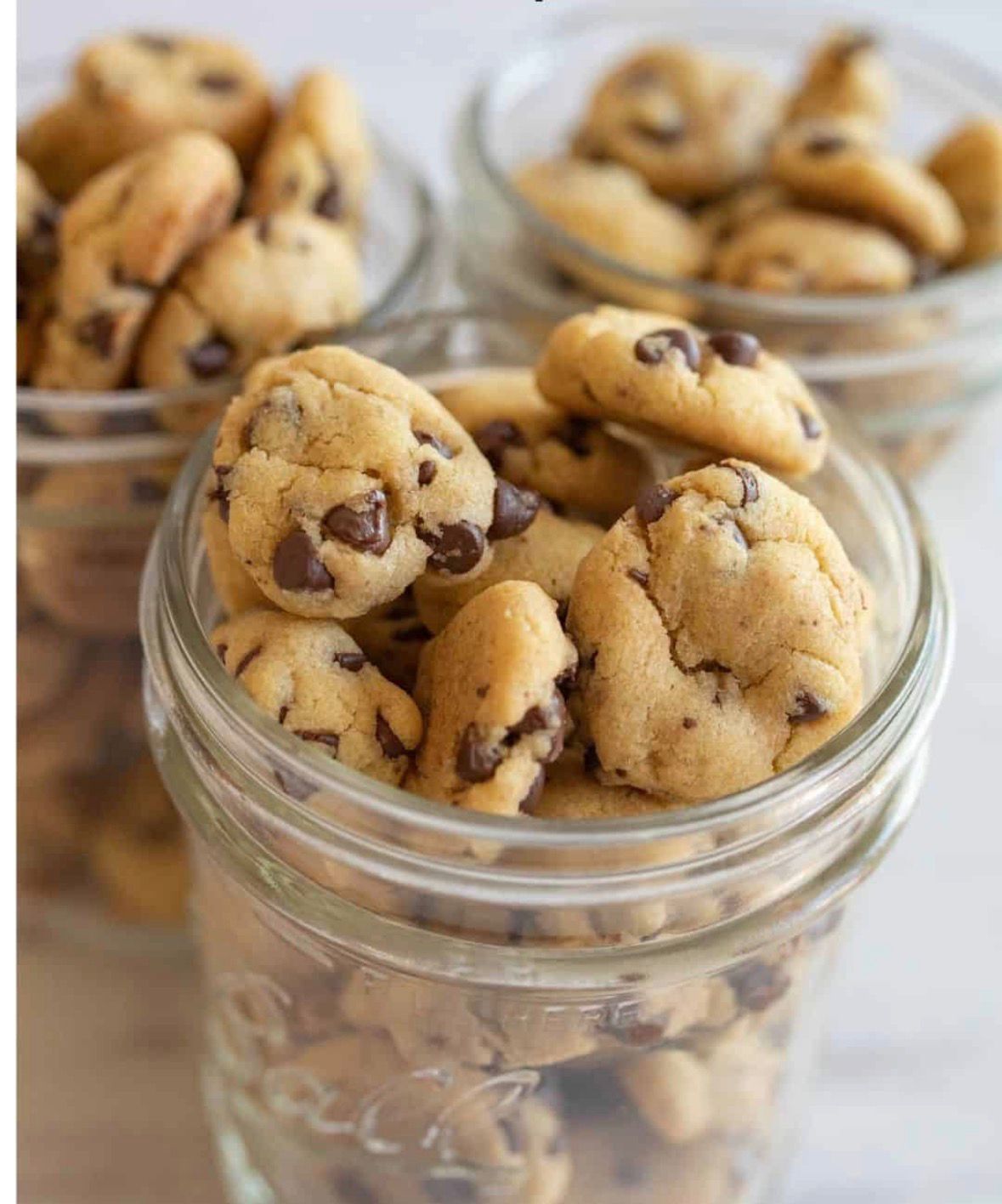 Mini chocolate chip cookies in a glass jar.